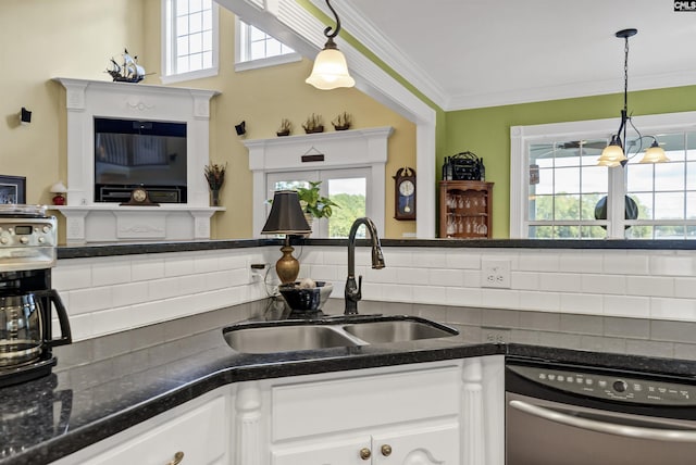 kitchen featuring a wealth of natural light, white cabinets, a sink, and dishwasher