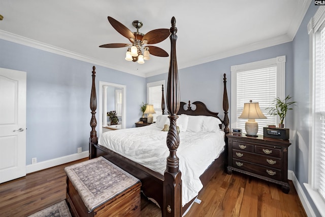 bedroom with crown molding, baseboards, and dark wood-style flooring