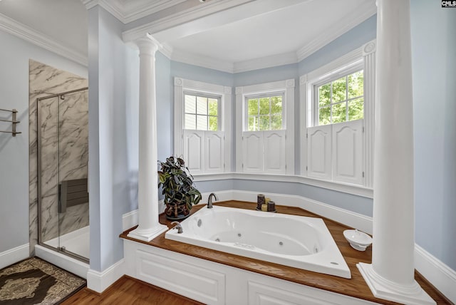 full bath featuring a jetted tub, a marble finish shower, decorative columns, and crown molding