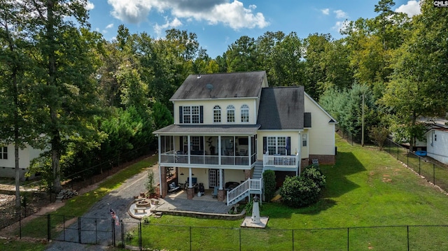 back of house featuring dirt driveway, stairway, a sunroom, a patio area, and a fenced backyard