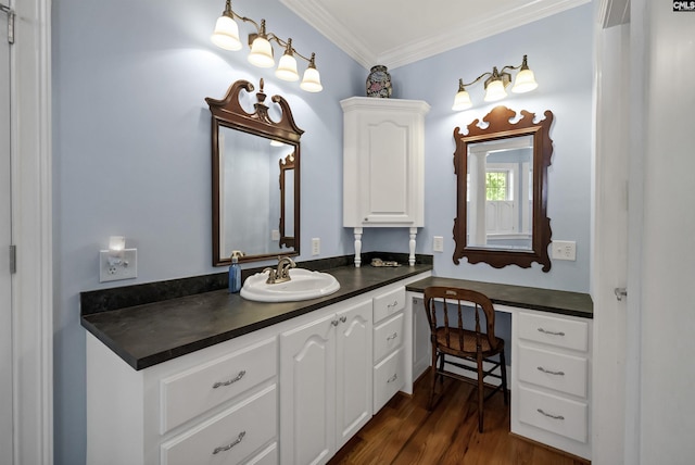 bathroom featuring ornamental molding, wood finished floors, and vanity