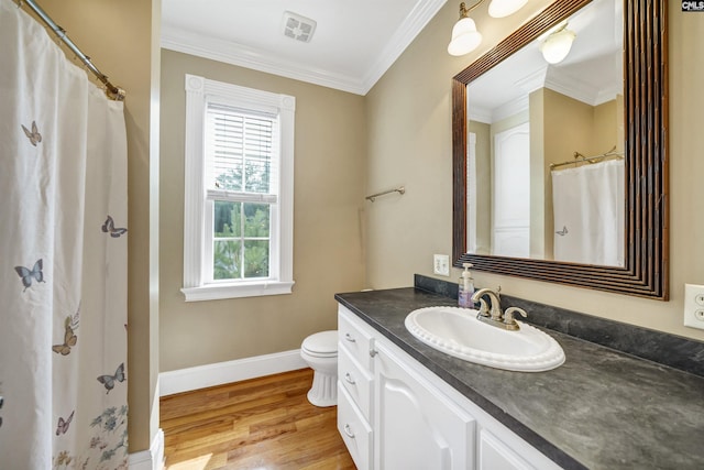 full bathroom featuring crown molding, visible vents, vanity, wood finished floors, and baseboards