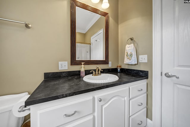 bathroom featuring crown molding and vanity