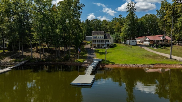 view of dock with a water view and a lawn