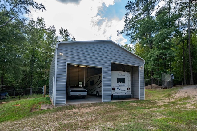 detached garage featuring fence