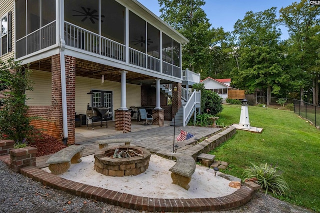 back of property featuring a patio, stairway, a sunroom, ceiling fan, and a fire pit