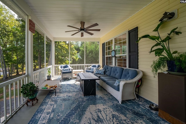 sunroom / solarium featuring wooden ceiling and a ceiling fan