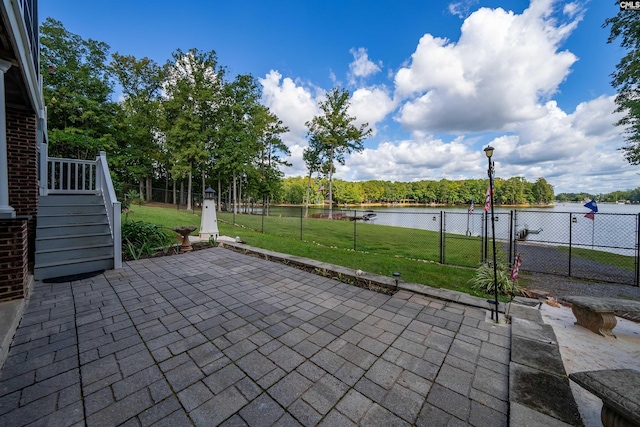 view of patio / terrace with a gate, a water view, a fenced backyard, and stairs