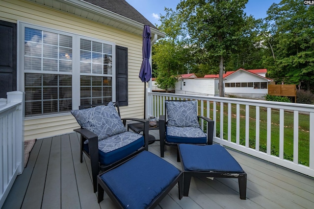 wooden terrace featuring a lawn