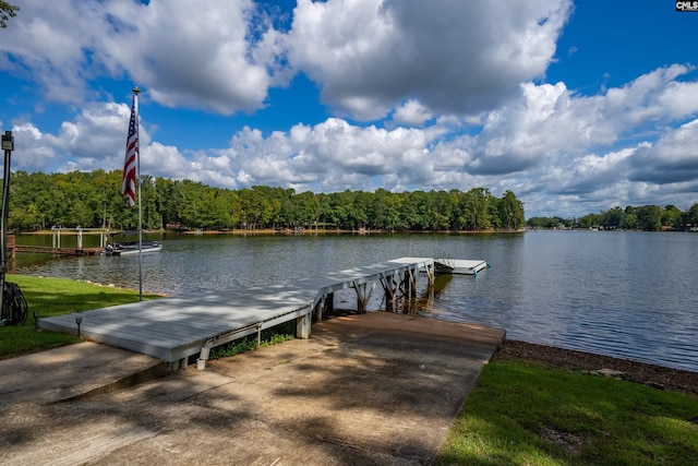 dock area featuring a forest view and a water view