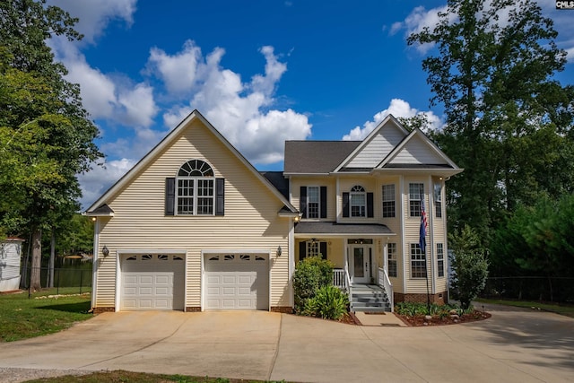 view of front of home with fence and driveway