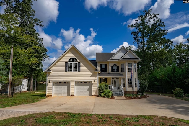 view of front facade featuring fence and concrete driveway