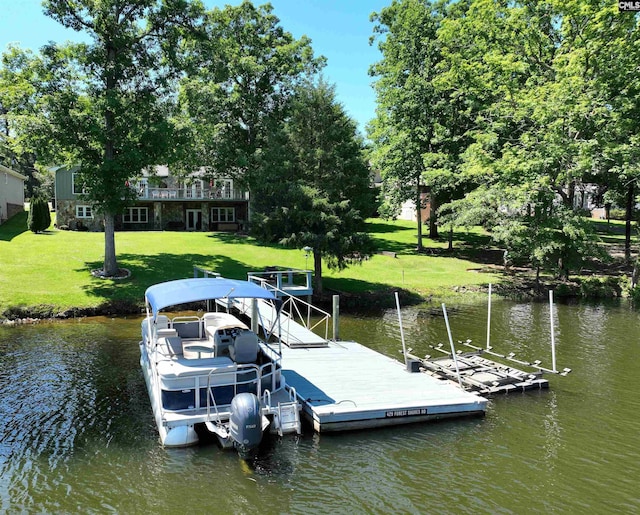 dock area with a water view and a lawn