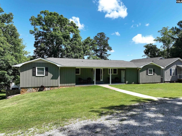 single story home with roof with shingles, board and batten siding, and a front yard