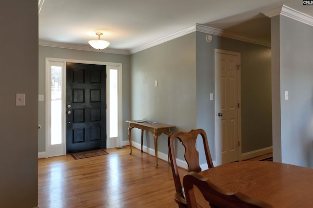 entryway featuring light wood-type flooring, baseboards, and ornamental molding