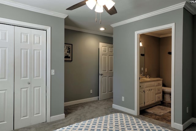 carpeted bedroom with baseboards, a ceiling fan, connected bathroom, crown molding, and a closet