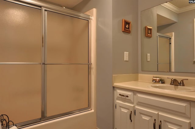 full bath featuring ornamental molding, shower / bath combination with glass door, and vanity