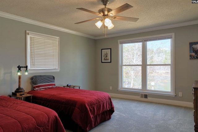 carpeted bedroom featuring ornamental molding, visible vents, a textured ceiling, and baseboards