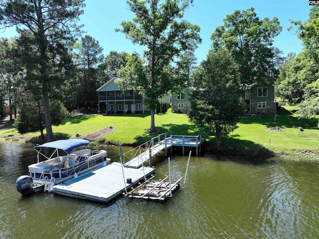 view of dock featuring a lawn and a water view