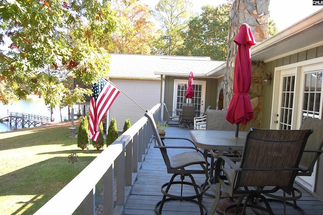 deck featuring a yard and outdoor dining space