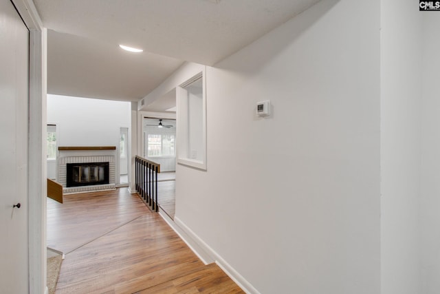 hallway with baseboards and light wood finished floors