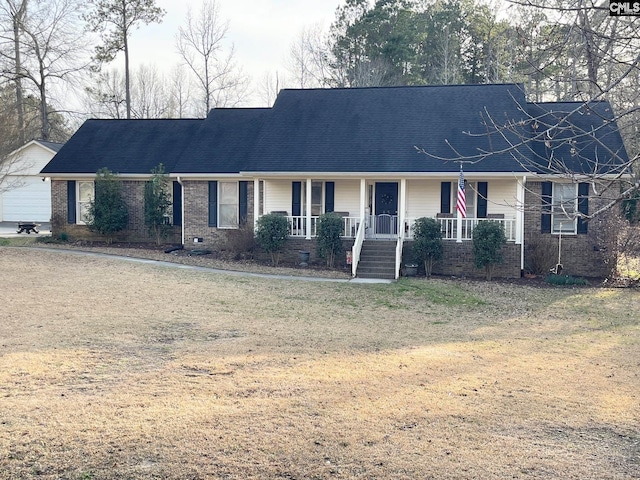 single story home with a porch, brick siding, a front lawn, and roof with shingles