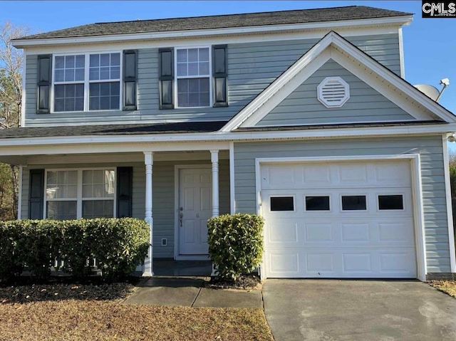 traditional-style home with a garage, concrete driveway, and covered porch