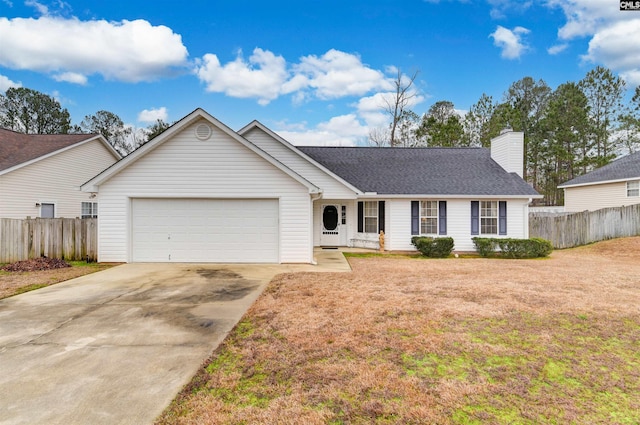 ranch-style home featuring a garage, driveway, fence, and a front yard