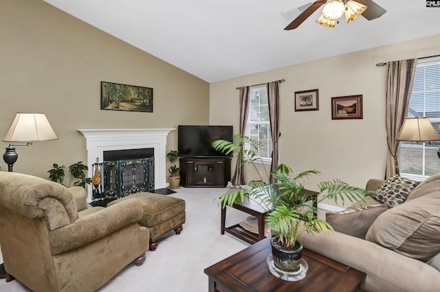 living room with lofted ceiling, light colored carpet, visible vents, a fireplace with flush hearth, and ceiling fan