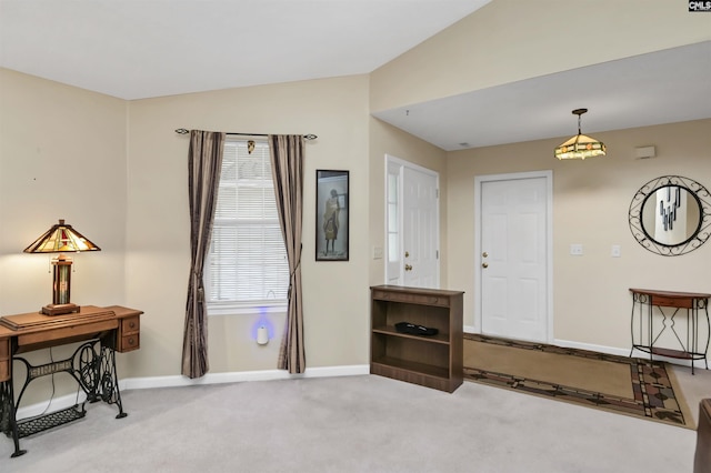 sitting room with carpet floors, baseboards, and vaulted ceiling