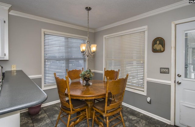 dining room featuring a chandelier, ornamental molding, and baseboards