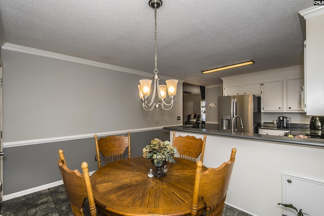 dining space featuring an inviting chandelier, baseboards, ornamental molding, and a textured ceiling
