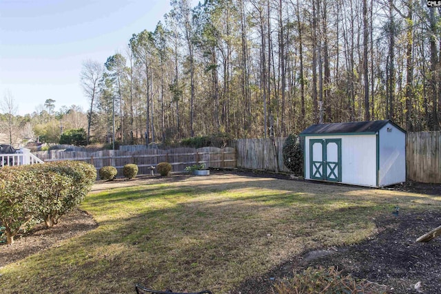 view of yard featuring a storage unit, an outdoor structure, and a fenced backyard