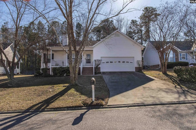 single story home with covered porch, driveway, and an attached garage