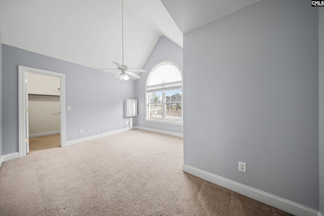 empty room with vaulted ceiling, carpet floors, and baseboards