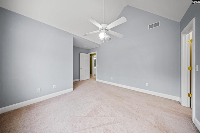 carpeted empty room with a ceiling fan, lofted ceiling, visible vents, and baseboards