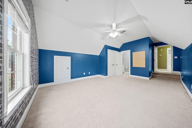 bonus room featuring a ceiling fan, lofted ceiling, carpet flooring, and baseboards