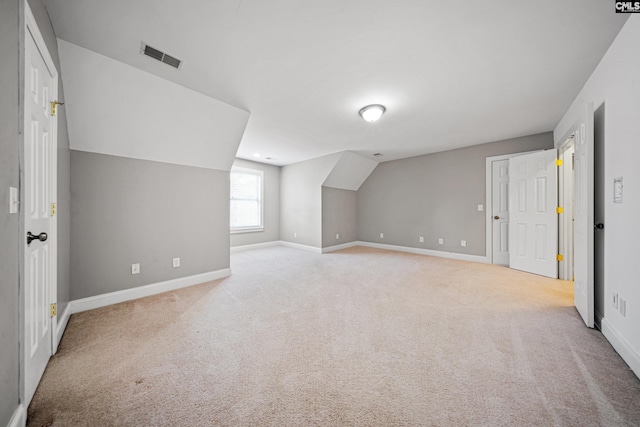 bonus room with vaulted ceiling, carpet, visible vents, and baseboards