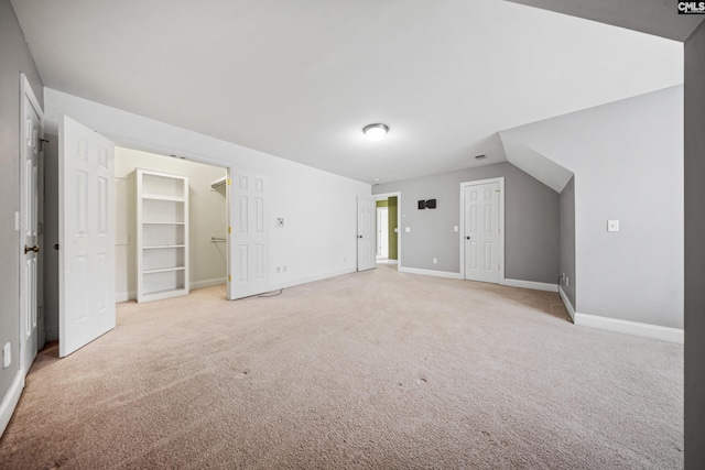 interior space featuring light colored carpet and baseboards