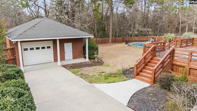 view of yard with a garage, an outdoor structure, and fence