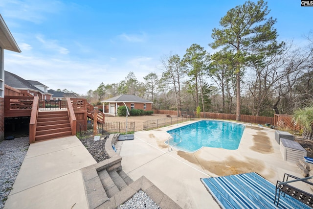 view of swimming pool featuring a fenced in pool, a patio area, a deck, a fenced backyard, and stairs