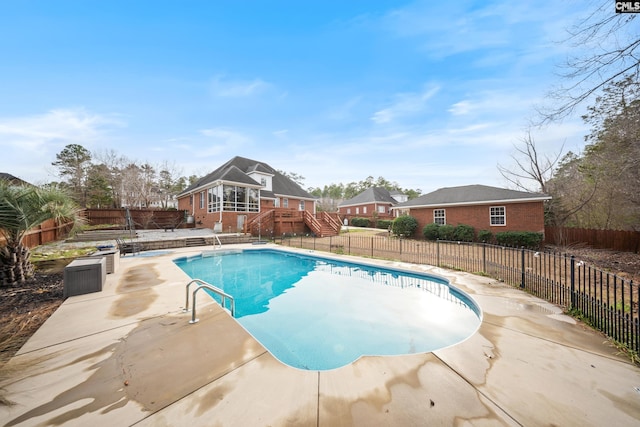 view of swimming pool featuring a patio area, a fenced backyard, stairway, and a fenced in pool