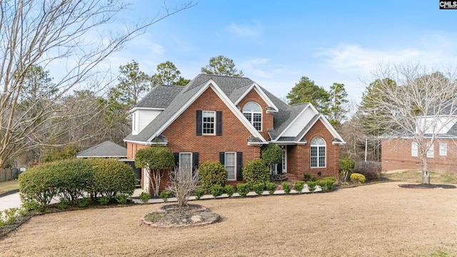 view of front facade featuring a shingled roof and brick siding