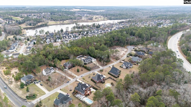 drone / aerial view with a water view and a residential view