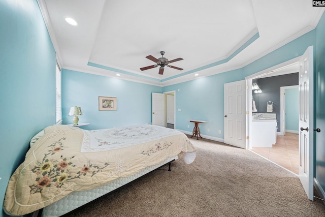 bedroom with ornamental molding, carpet flooring, a raised ceiling, and baseboards