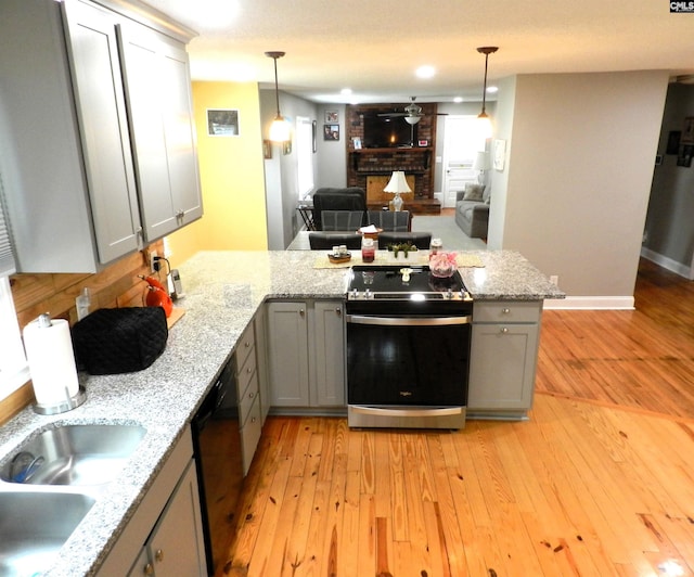 kitchen featuring gray cabinetry, decorative light fixtures, a peninsula, and electric range oven