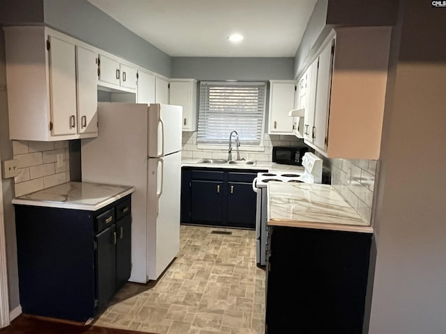 kitchen with dark cabinets, a sink, white cabinetry, electric stove, and light countertops