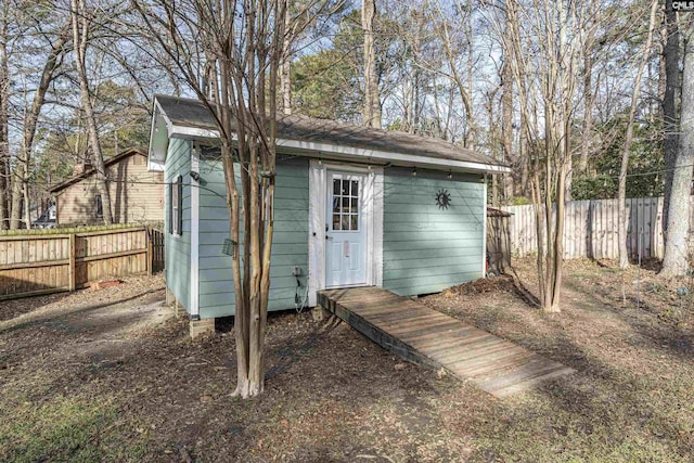 view of outbuilding with an outbuilding and fence