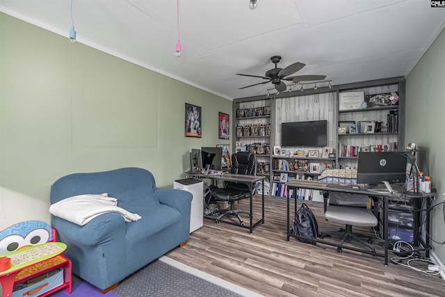 home office featuring wood finished floors, a ceiling fan, and crown molding