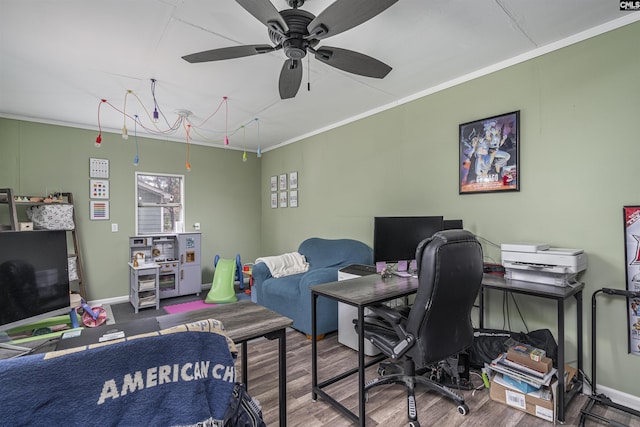 office space featuring baseboards, ornamental molding, ceiling fan, and wood finished floors